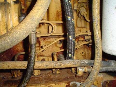 1966 International School Bus - Close-up view of engine components, including hoses and a filter, with visible rust.