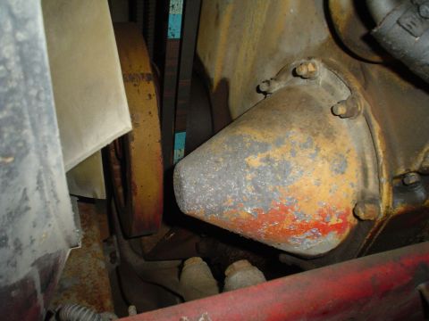 1966 International School Bus - Close-up view of a water pump and fan belt assembly within an engine compartment.