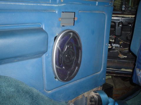 1984 Ford Bronco - Close-up of a blue interior door panel showing a speaker and exposed wiring.