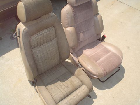 1995 Ford Taurus - Two tan car seats, one with a patterned fabric insert, are shown outside.