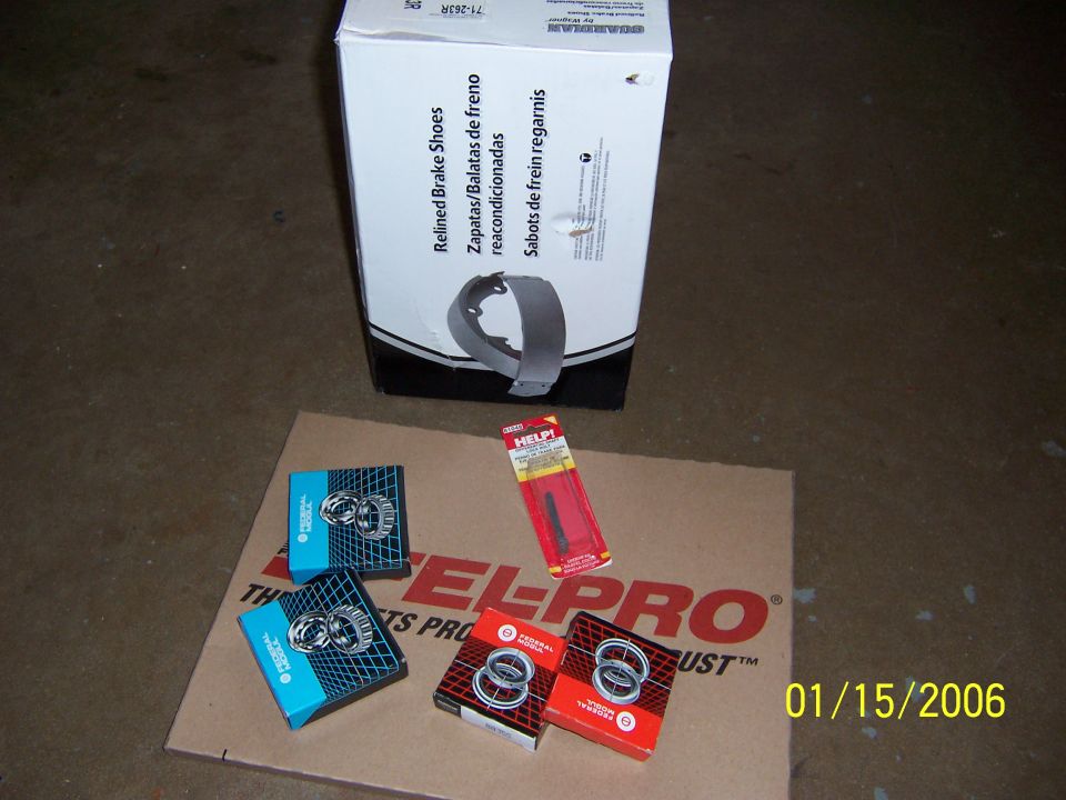 Box of brake shoes and bearing boxes on cardboard