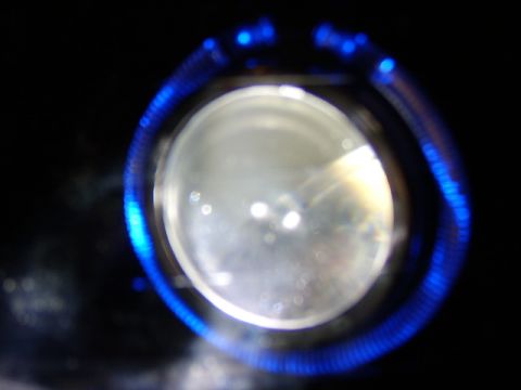 1998 Ford Taurus - A car headlight assembly features a bright blue LED halo ring around the main lens.