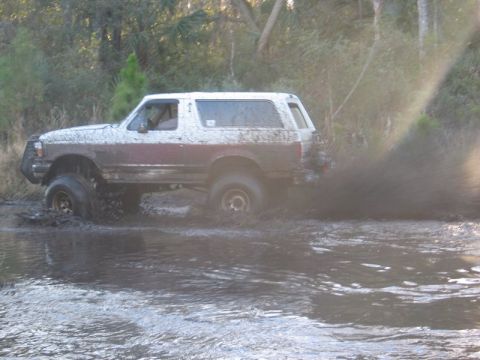 1995 Ford Bronco - 1995 Ford Bronco splashing through water during an off-road run.
