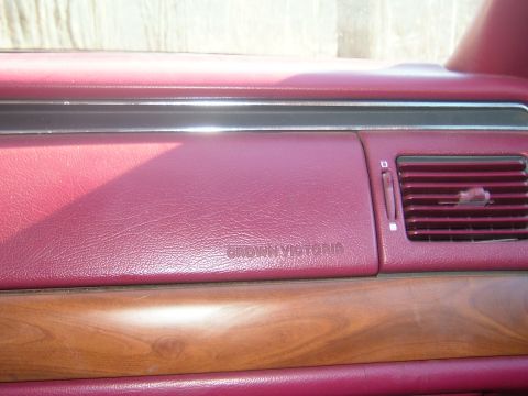 1984 Ford Bronco - Close-up of the dashboard showing the 'Crown Victoria' nameplate and wood grain trim.