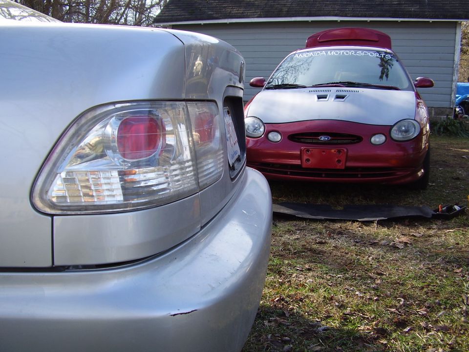 red and silver car with hood scoop and "AMONDA MOTORSPORTS" sticker on windshield
