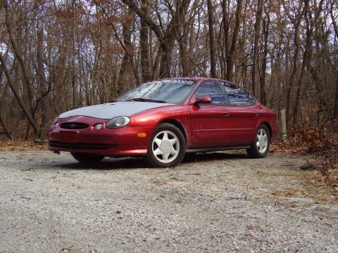 1997 Ford Taurus - This 1997 Ford Taurus is shown in a three-quarter front view, a red body and a contrasting grey hood.