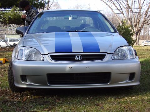 1997 Ford Taurus - Front view of a silver Honda Civic with blue racing stripes on the hood.