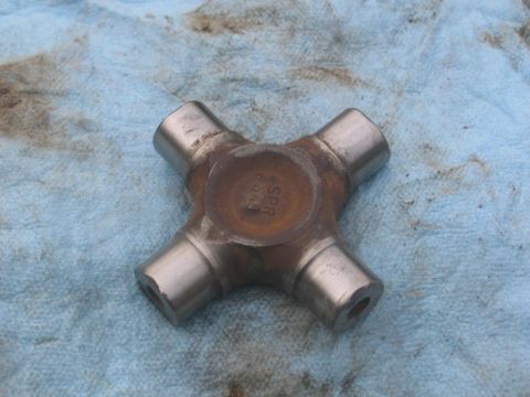 1995 Ford Bronco - A universal joint part, possibly from a Ford Bronco, is shown with visible stamping on its center bearing.