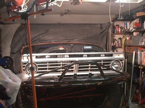 1978 Ford Bronco - The grille of a Ford truck is visible, with the word "FORD" spelled out across it.
