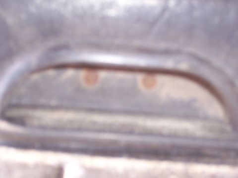1978 Ford Bronco - The photo shows a close-up of a vehicle's headlight assembly, with two circular reflectors visible.