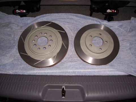 1998 Mercury Sable - Two slotted brake rotors are displayed on a towel, likely for sale or replacement.