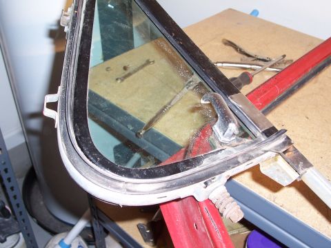 1978 Ford Bronco - A disassembled car door window frame is shown with various tools nearby, suggesting repair or replacement.