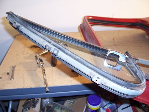 1978 Ford Bronco - A detached door window assembly, including the frame and glass, rests on a workbench alongside various tools.