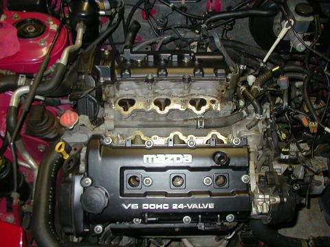 1997 Ford Probe - Engine bay view of a Mazda V6 DOHC 24-valve engine, with the intake manifold removed.