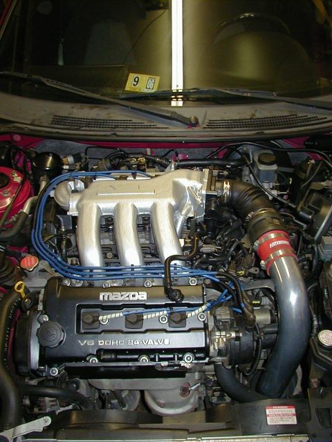 1997 Ford Probe - Mazda V6 engine bay, showing intake manifold, spark plug wires, and other engine components.