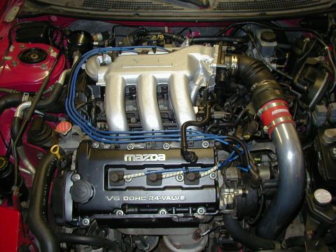 1997 Ford Probe - Close-up of a Mazda V6 engine, highlighting the intake manifold and spark plug wires.