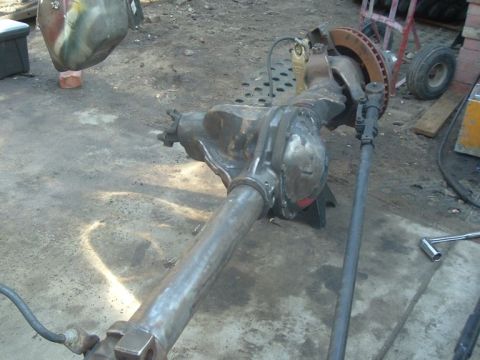 1988 Ford Bronco - A heavily modified front axle assembly, likely for an off-road vehicle, is shown in a workshop setting.