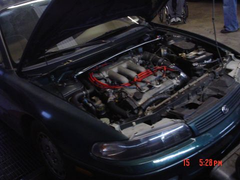 1994 Mazda 626 - Engine bay of a 1994 Mazda 626, V6 engine visible with hood up. Timestamp 15:5:28 PM.