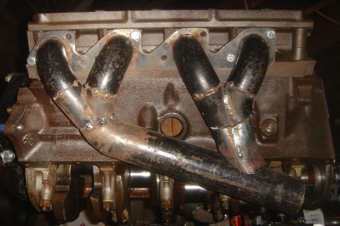 1969 Ford Mustang - This image shows a close-up view of an engine block with custom-fabricated exhaust headers, not a complete vehicle.