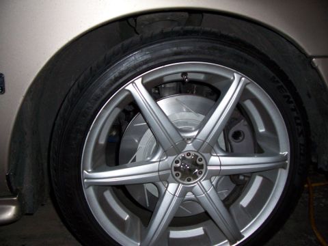 1998 Mercury Sable - Aftermarket wheel and drilled brake rotor assembly on a vehicle.