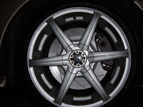 1998 Mercury Sable - This image shows a close-up of a vehicle's wheel, custom rims and slotted brake rotors, not a 1998 Mercury Sable.