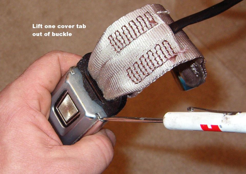 Since I also wanted to wash the seat belts, I disassembled the buckle. After working the blade tip into the gap as shown, rotate the screwdriver counterclockwise gently. On the other side, rotate clockwise to pull the tab out of the chrome frame & lift the cover away from the belt.

SEE THE NEXT 6 PICS...