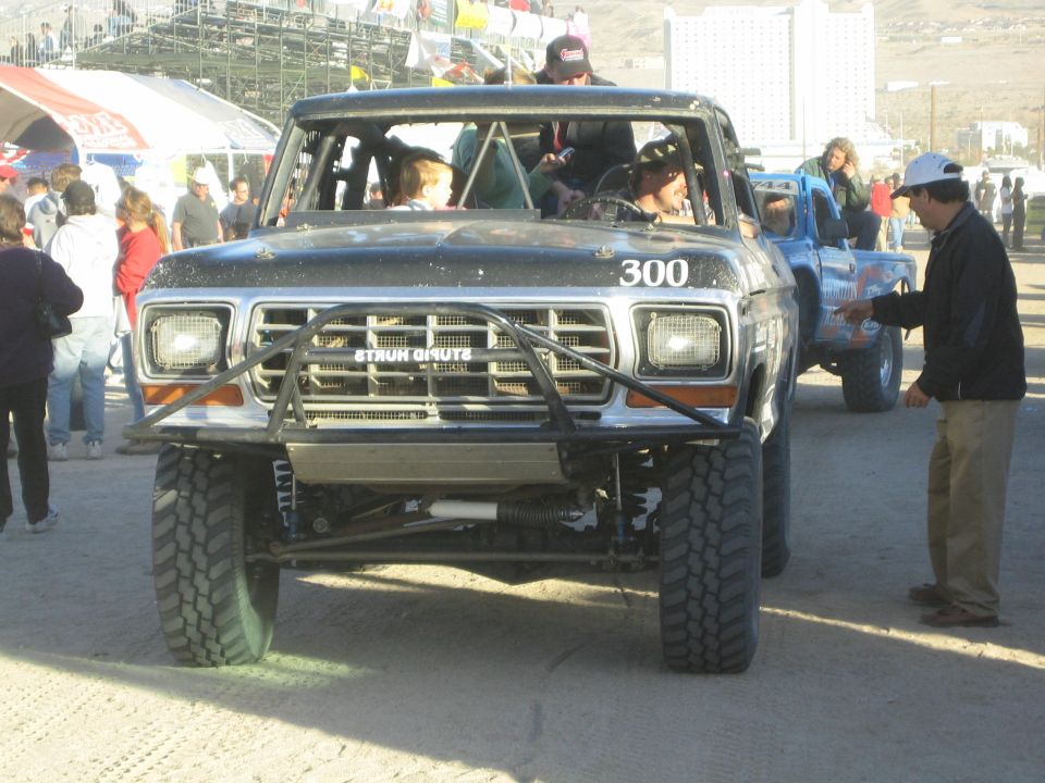 Front view of black Ford race truck 300 with people gathered around it