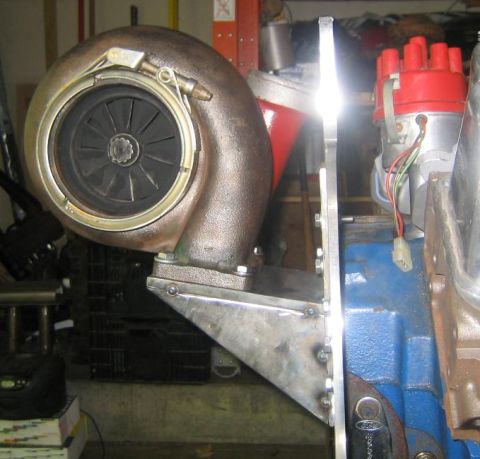 1969 Ford Mustang - Close-up of a turbocharger and engine components, including a distributor.