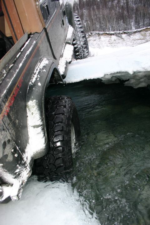 2003 Jeep TJ - Jeep Wrangler TJ navigating a cold, icy stream during winter conditions.