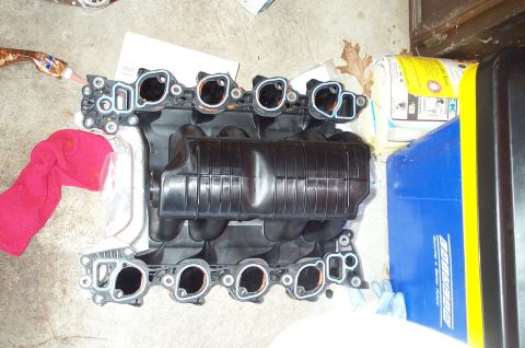 1998 Ford Crown Victoria - An intake manifold is shown, likely for a Ford Crown Victoria, with gasket surfaces exposed.