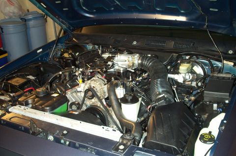1998 Ford Crown Victoria - Engine bay of a 1998 Ford Crown Victoria, showing the V8 engine and associated components.