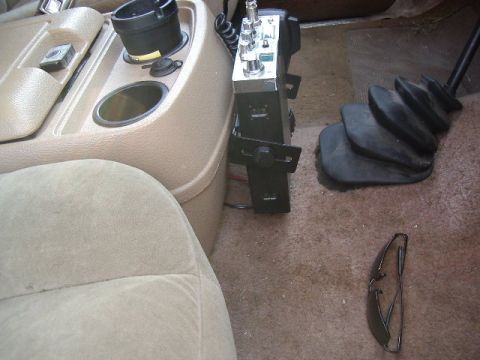 1985 Ford Bronco - Interior view showing a CB radio mounted on the center console, adjacent to the gear shifter and cup holder.
