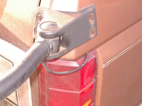 1985 Ford Bronco - CB antenna mount hardware attached to the body near the tail light of a 1985 Ford Bronco.
