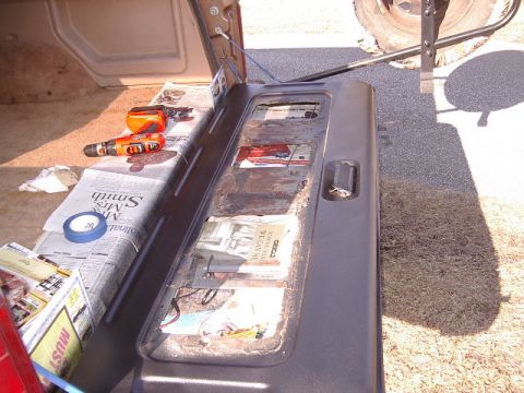 1985 Ford Bronco - Tailgate interior of a Ford Bronco, prepared for work with tools and newspaper.