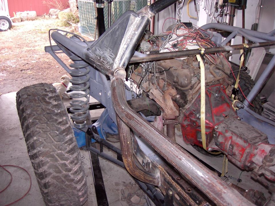 Custom buggy frame with exposed engine, suspension, and large tire