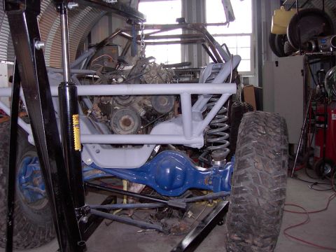 1981 Ford F-150 - Custom off-road vehicle chassis with engine and suspension parts visible in a workshop.