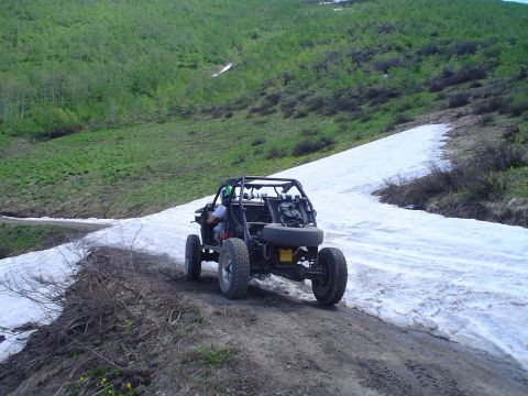 1981 Ford F-150 - A buggy navigates a snowy mountain trail, its off-road capabilities.