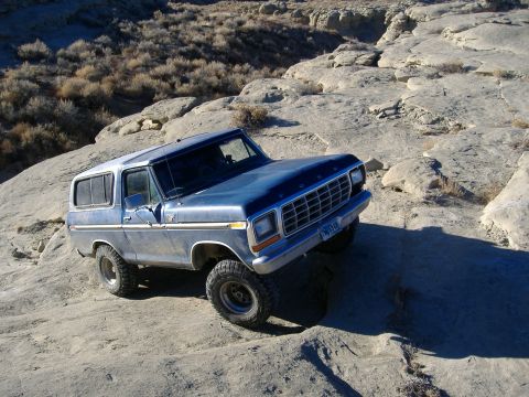 1978 Ford Bronco - This 1978 Ford Bronco navigates a rocky, off-road terrain under a clear sky.