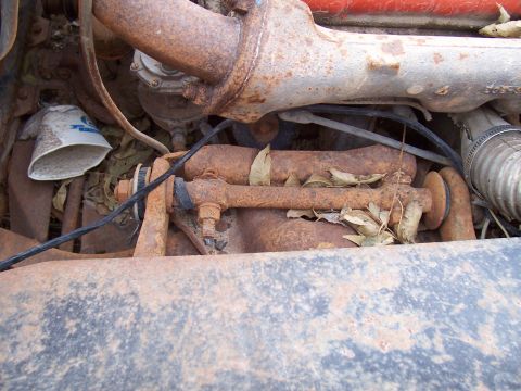 1955 Ford Customline - Close-up view of corroded engine components and a dirty oil filter.