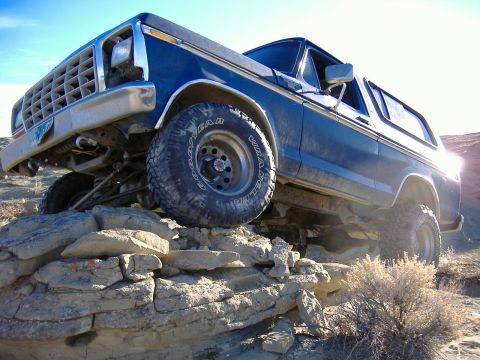 1978 Ford Bronco - This blue 1978 Ford Bronco navigates a rocky trail, its off-road capabilities.
