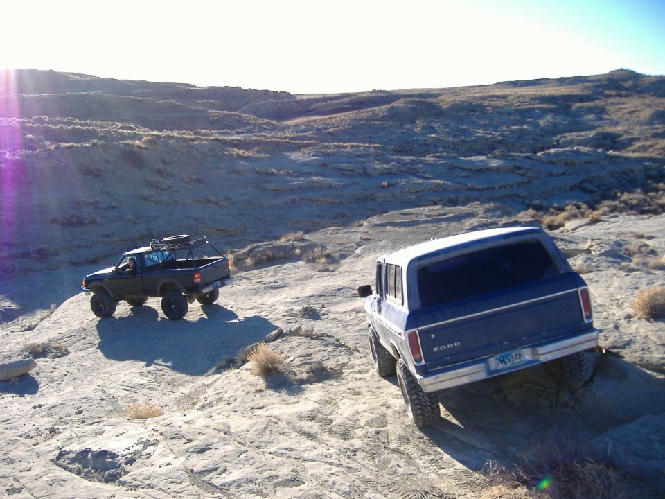 Blue 1978 Ford Bronco rear view on rocky terrain