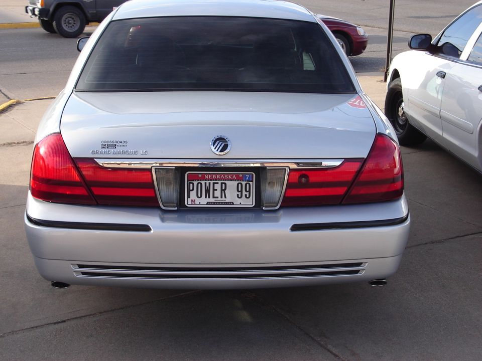 Silver 2000 Ford Crown Victoria Grand Marquis LS rear view with Nebraska license plate "POWER 99"