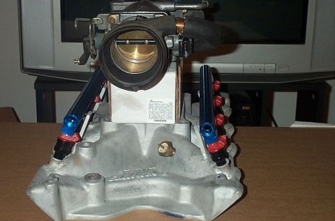 1978 Ford F-250 - Aftermarket throttle body and intake manifold assembly with fuel rails, likely for a performance engine build.