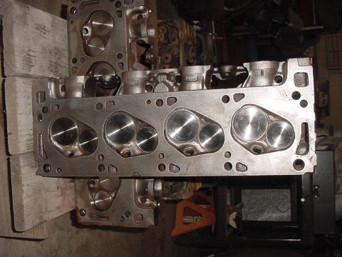 1978 Ford F-250 - Engine cylinder heads are shown, with one unit resting on top of another in a workshop setting.