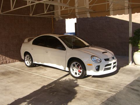 1996 Ford Probe - This white sedan, likely a Dodge Neon SRT-4, is shown from a three-quarter front angle under a covered patio.