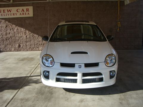 1996 Ford Probe - Front view of a white Dodge Neon SRT-4 parked indoors.