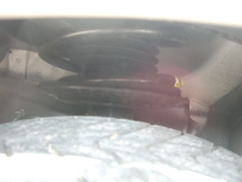 1996 Ford Probe - Detail of a vehicle's suspension system, showing the coil spring and tire.
