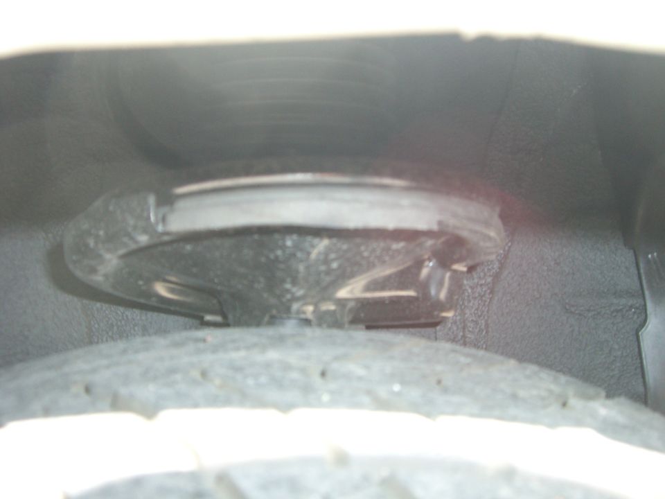 Close-up of a car's suspension spring and mount