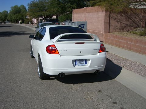 1996 Ford Probe - Rear view of a white Dodge SRT-4 parked on a residential street.