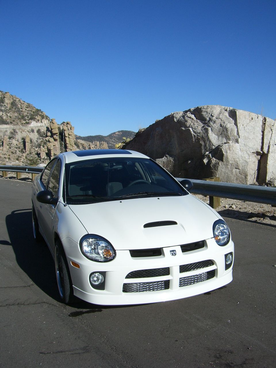 White Dodge Neon SRT-4 front view with hood scoop and aggressive grille